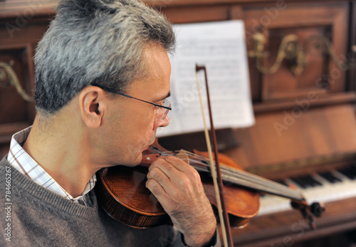 man and violin with score photo