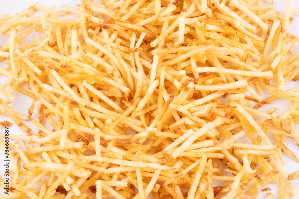 shoestring potatoes scattered in white background shoestring potatoes scattered in white background