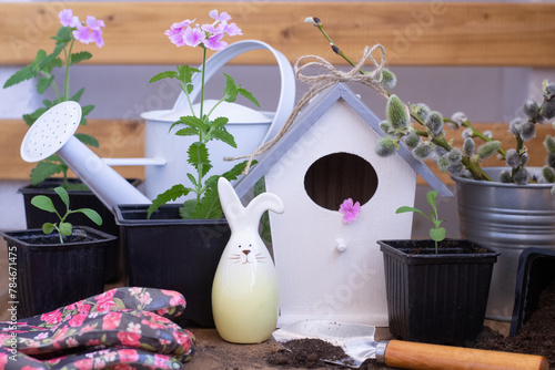 gardening tools, flowers, birdhouse.  Easter concept