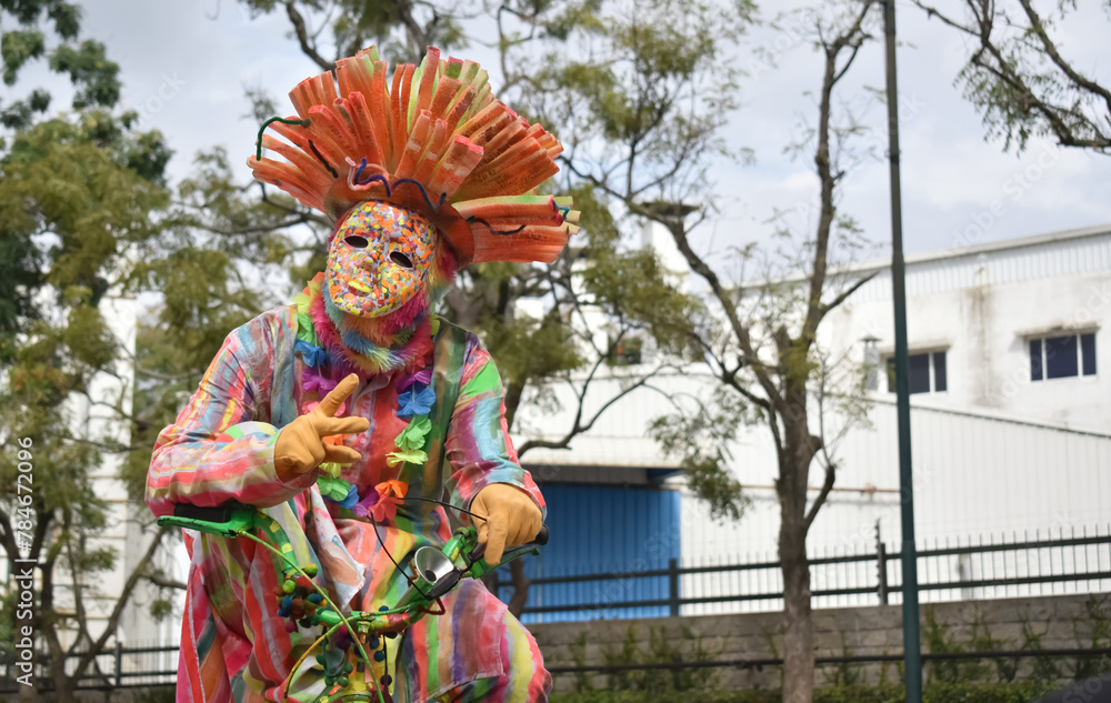 A closeup picture of a clown or a Joker posing to the camera wearing a funny mask. A closeup picture of a clown or a Joker posing to the camera wearing a funny mask.
