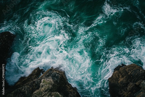 Aerial View of the Ocean, A top-down view of green sea waves washing over rocky ledges, AI Generated