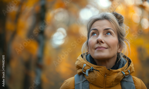 50 year old woman, going for a hike, beautiful wilderness, looking up and feeling inspired, photo realistic, high angle, 35mm lens, Hyper realistic photo. very detailed © Natali