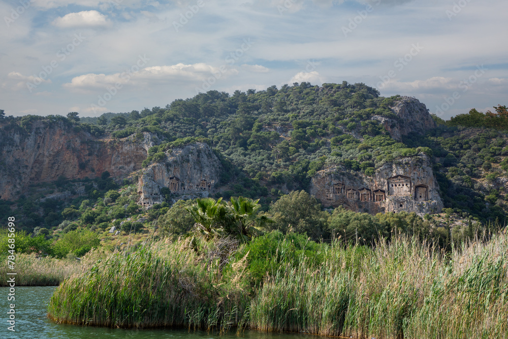 Obraz premium See Lycian Rock Tombs, one of the ancient architectural wonders of Turkey, carved into the cliffs facing the town of Dalyan. Mugla-Turkey