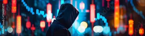 Hooded Figure Against Vibrant City Lights at Night photo