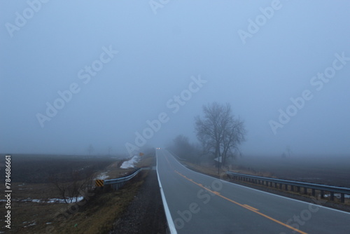 A car travels down a foggy road  © Joel