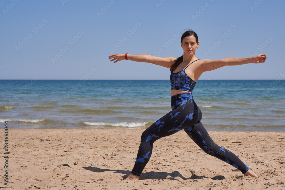 Healthy woman in sportswear doing exercise on the beach Healthy woman in sportswear doing exercise on the beach