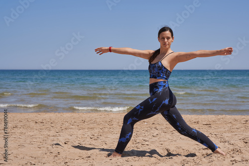 Healthy woman in sportswear doing exercise on the beach