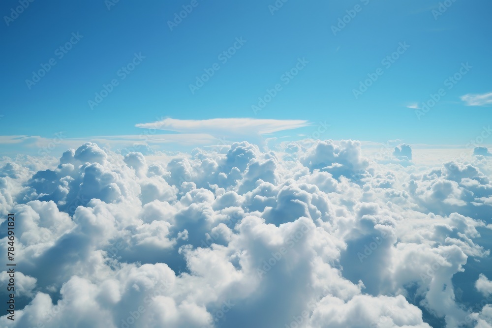 Fototapeta premium This photo captures a stunning view of the clouds as seen from the window of an airplane flying at high altitude, A view of spacious white clouds in a bright blue sky, AI Generated