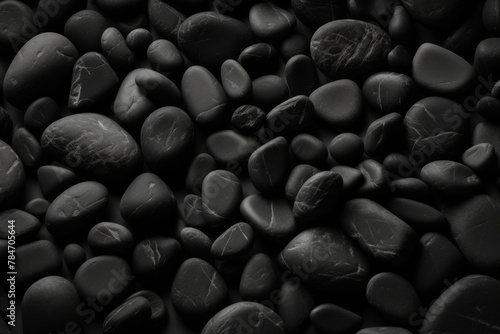 Smooth black pebbles with subtle highlights, ideal for zen-inspired themes and minimalist designs