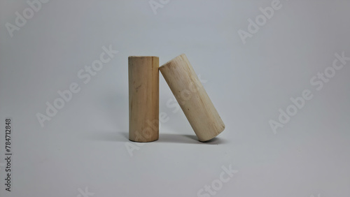 two wooden sticks on a white surface photo