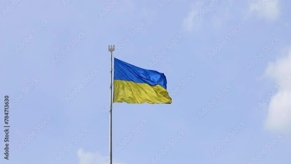 Ukrainian flag waving in the wind against blue sky Ukrainian flag waving in the wind against blue sky