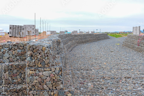 Gabion-faced soil retaining structures at the entrance of a home subdivision under construction in Pinal County, Arizona, 