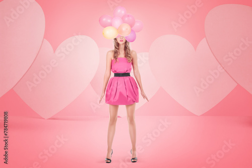 A young blonde woman wearing a pink dress and holding colorful balloons, posing against a heart shapes, cheerful and romantic scene related to love, celebrations, or embracing one's inner child.