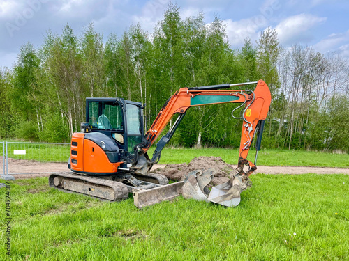 Mini crawler excavator for laying utilities on construction sites