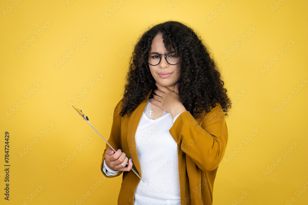 Obraz premium African american business woman with paperwork in hands over yellow background touching painful neck, sore throat for flu, clod and infection a plant isolated on yellow background