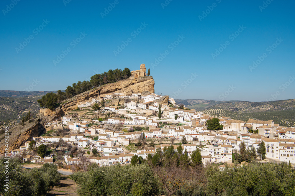 Old town Montefrio. The ruins of a Moorish castle on a rock and white houses under cloudless sky. Pueblos blancos, Andalusia, Spain. Spanish white villages Old town Montefrio. The ruins of a Moorish castle on a rock and white houses under cloudless sky. Pueblos blancos, Andalusia, Spain. Spanish white villages