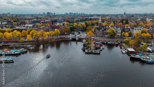 Aerial drone view Amsterdam autumn cityscape narrow old houses, canals, boats bird's eye view
