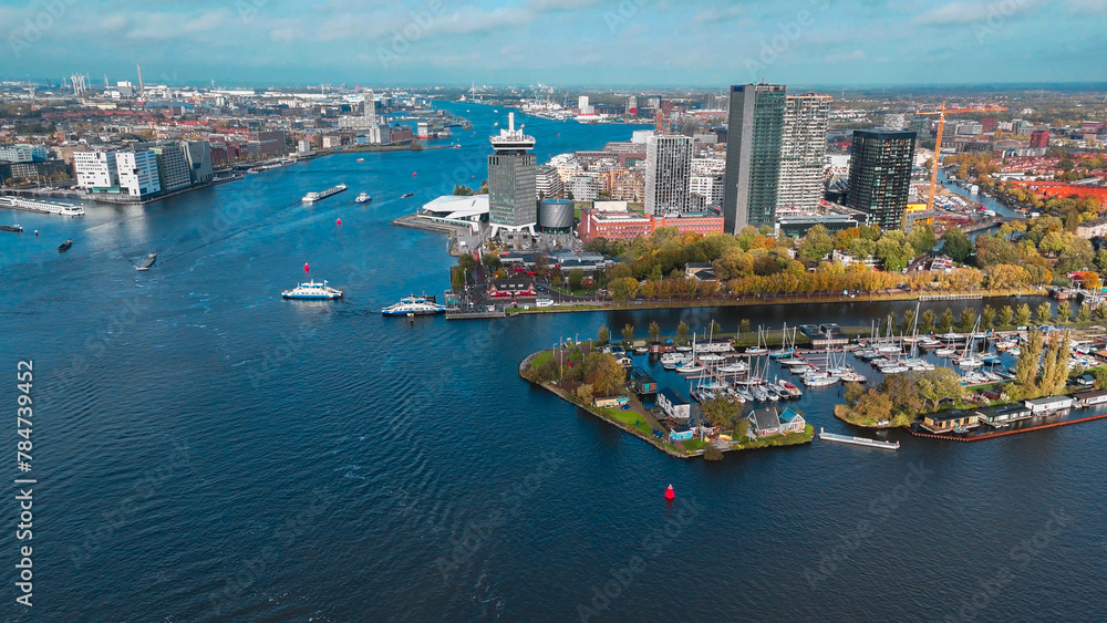 Obraz premium Aerial drone view Amsterdam autumn cityscape narrow old houses, canals, boats bird's eye view