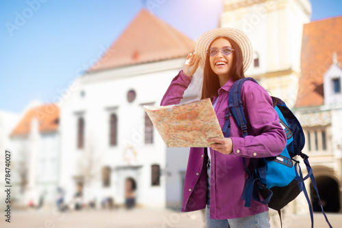 Tourist young woman with map and backpack