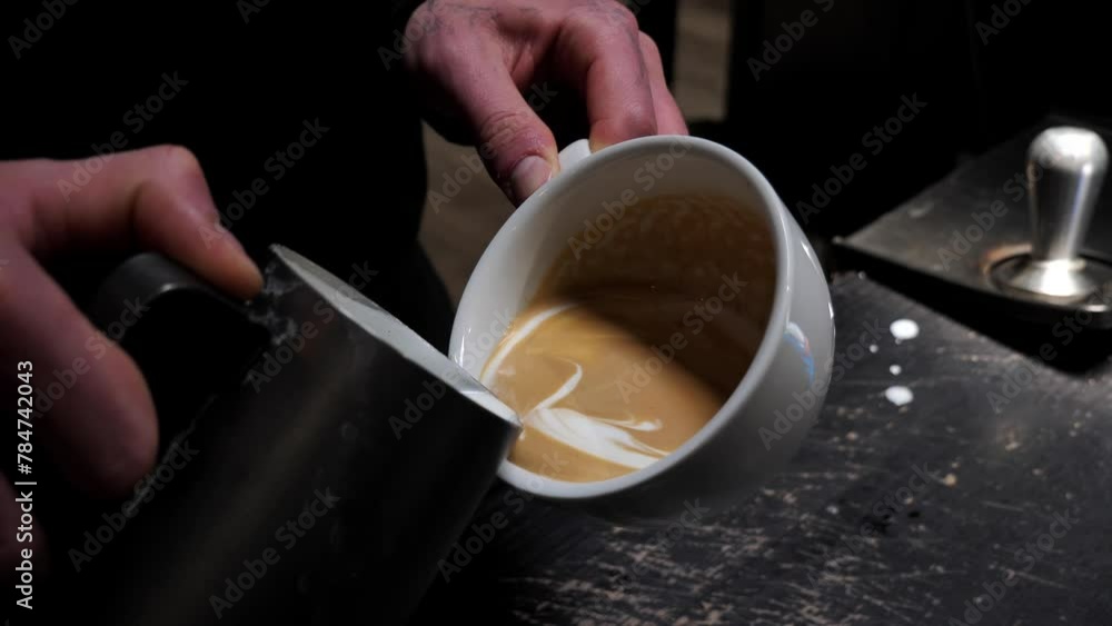 Barista makes latte art coffee. pattern in a cup of coffee