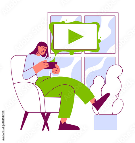 A woman sits with her phone and watches a video.