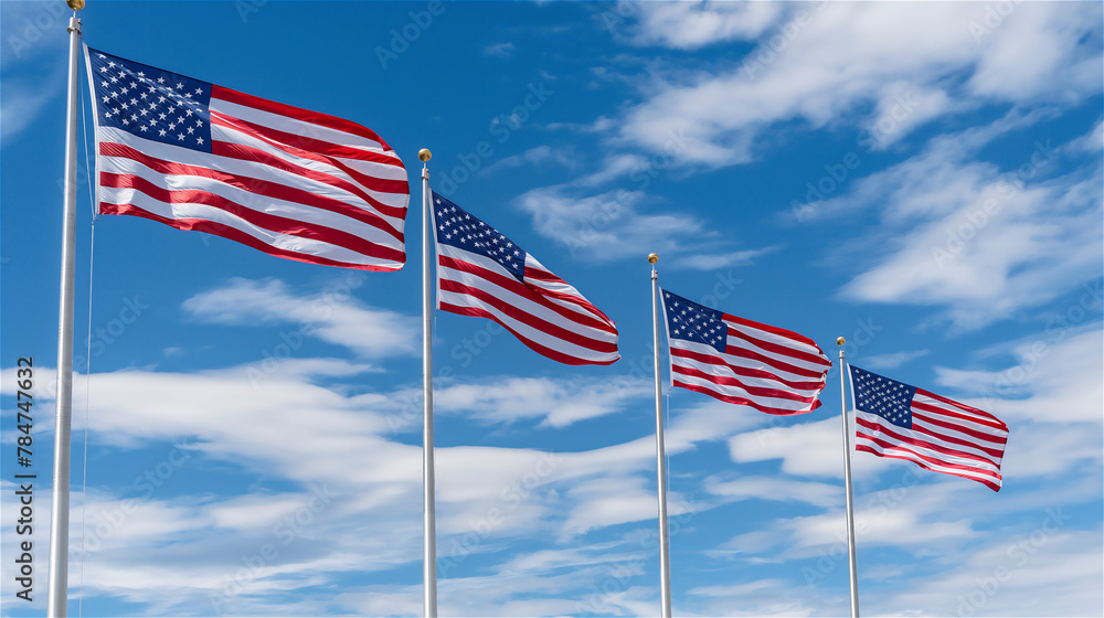 American flags flying on tall poles against a blue sky.
