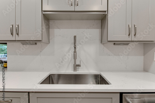 Modern Kitchen Sink with High Quality Pull Down Faucet Design, Neutral Cabinets and Marble Stone Backsplash