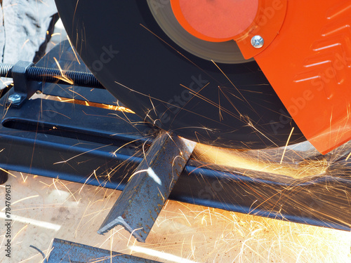 Obraz na płótnie Sparks from cutting metal with angle grinder. Sparks while grinding iron.
The concept of locksmith work, processing of metal products.
w salonie