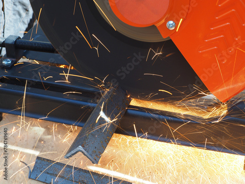 Obraz na płótnie Sparks from cutting metal with angle grinder. Sparks while grinding iron.
The concept of locksmith work, processing of metal products.
w salonie