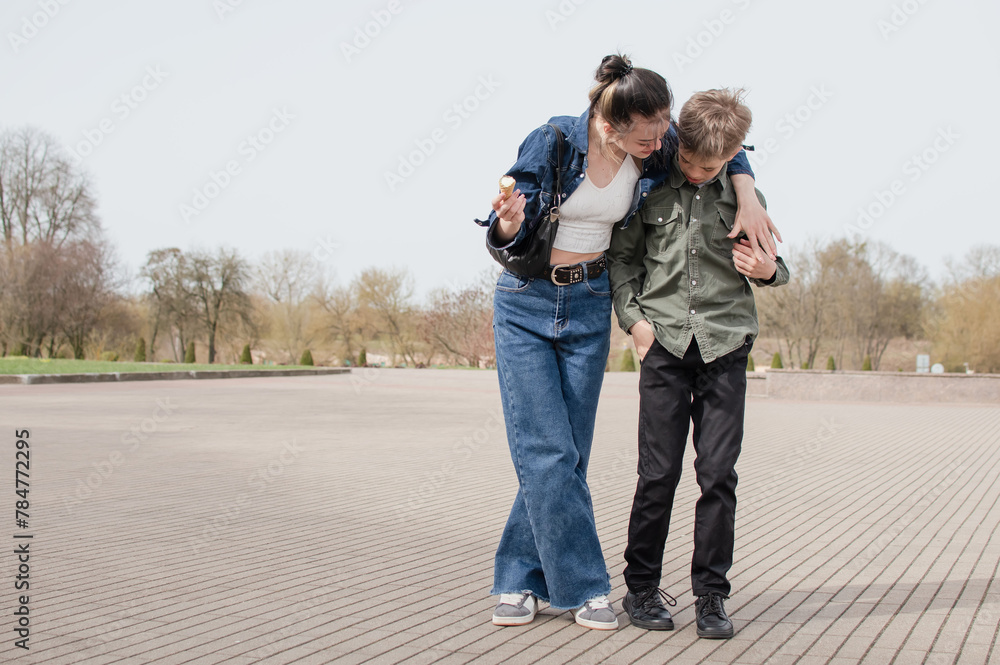 Sister and younger brother walking in the park Sister and younger brother walking in the park