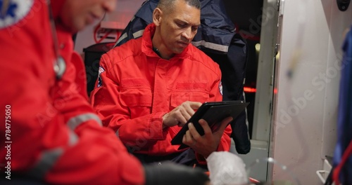 Talking, man and a tablet at sea for rescue emergency, communication and training at sea. Teamwork, digital and a medical employee working on a boat with tchnology for service, analysis or research photo