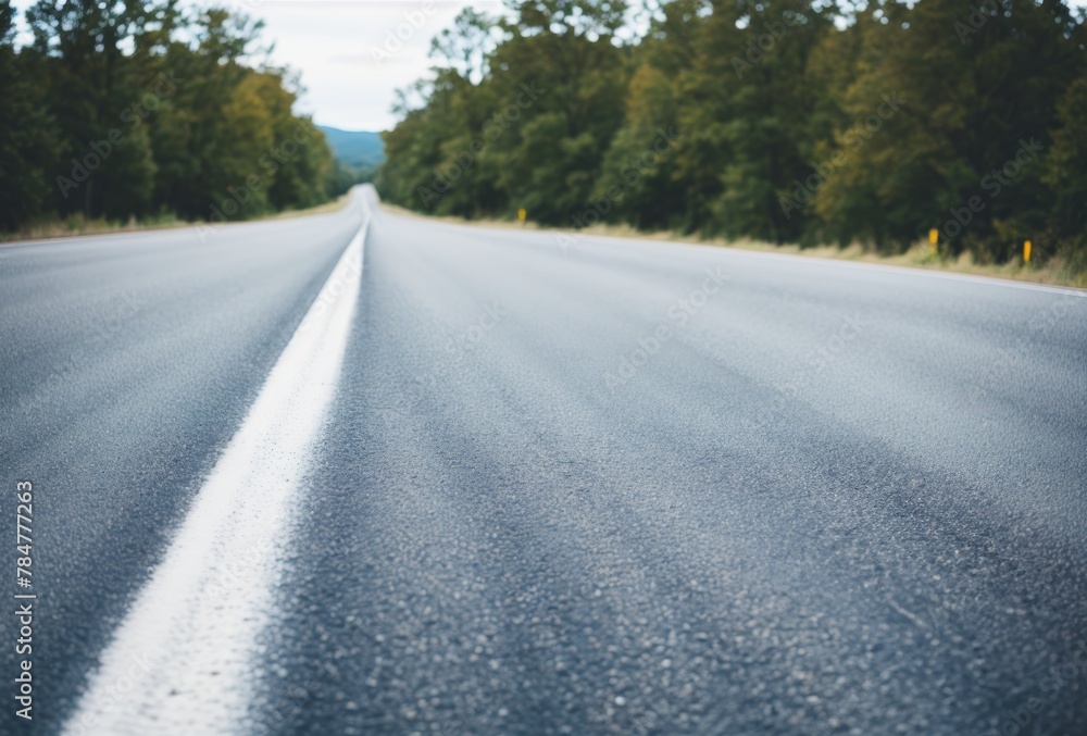 Obraz premium Detailed view of road texture, markings, blurred car in the distance. AI generated.
