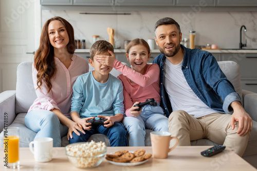 Siblings cover each other s eyes during gaming