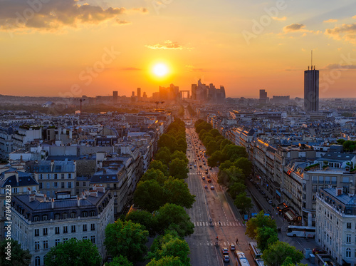 Skyline of Paris with la Defense is a major business district and Avenue de la Grande Armee in Paris, France. Panoramic sunset view of Paris