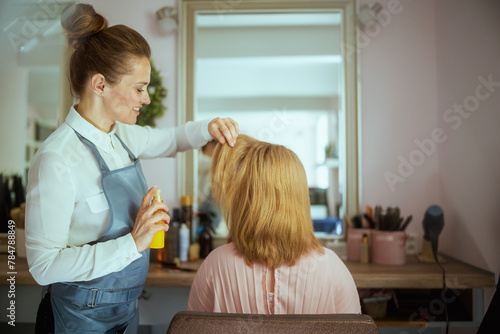 woman hair salon worker in modern beauty studio