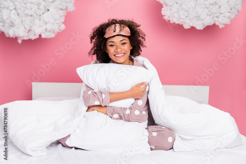 Photo of dreamy cheerful lady wear pajama smiling hugging pillow isolated pink color background