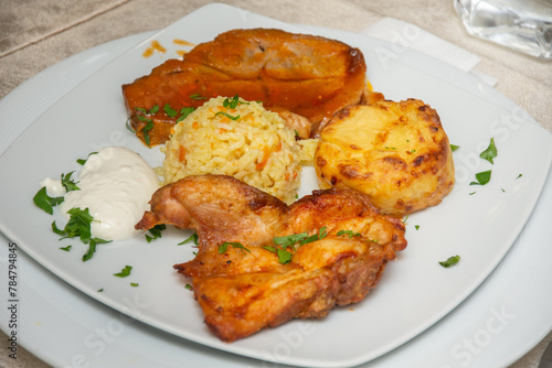 barbecue with chicken meat, fried potatoes and rice