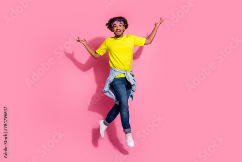 Photo of nice positive glad man wear stylish yellow clothes good mood jump up isolated on pink color background