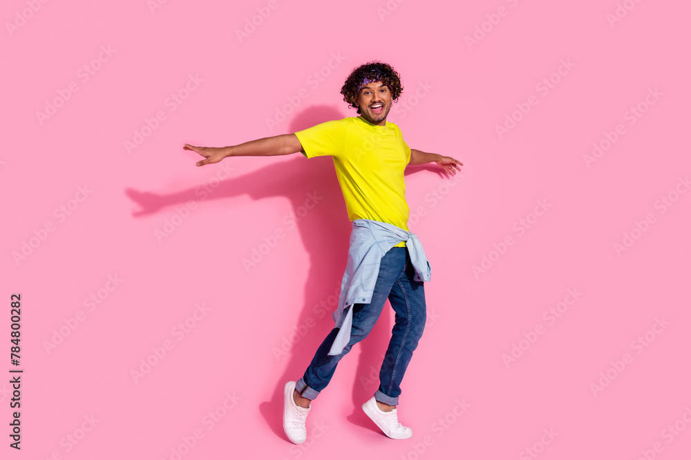 Photo of positive crazy cool man wear stylish yellow clothes active dance isolated on pink color background