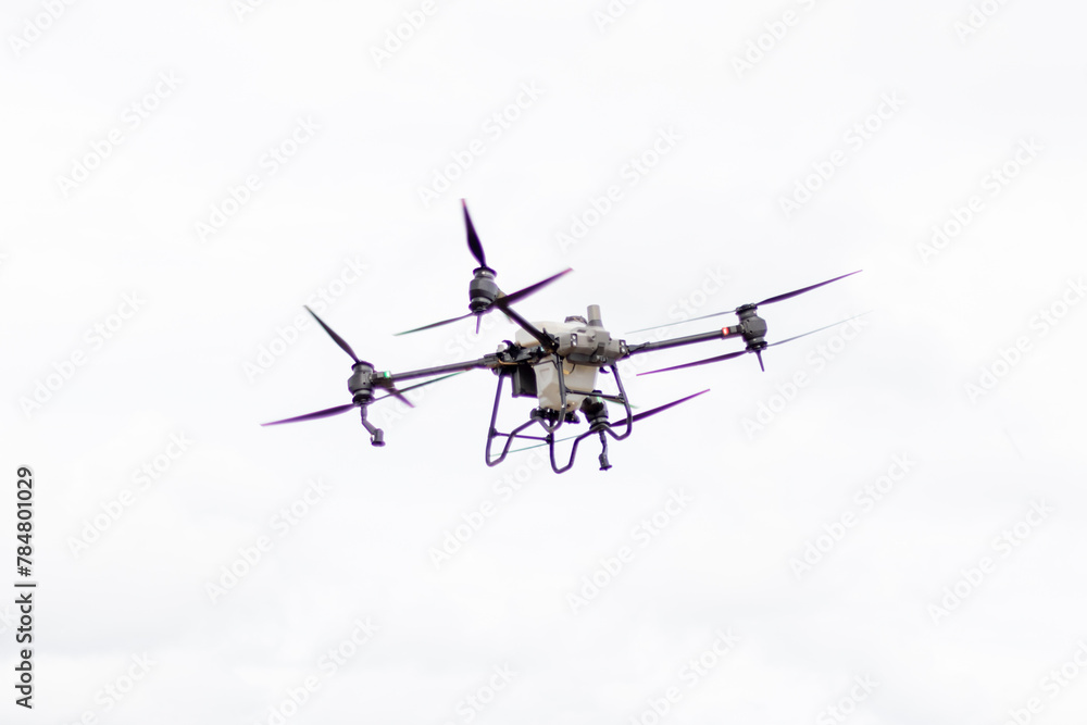 Unmanned aerial vehicle (UAV), commonly known as a drone, for agricultural fertilizer and pesticide spraying Unmanned aerial vehicle (UAV), commonly known as a drone, for agricultural fertilizer and pesticide spraying