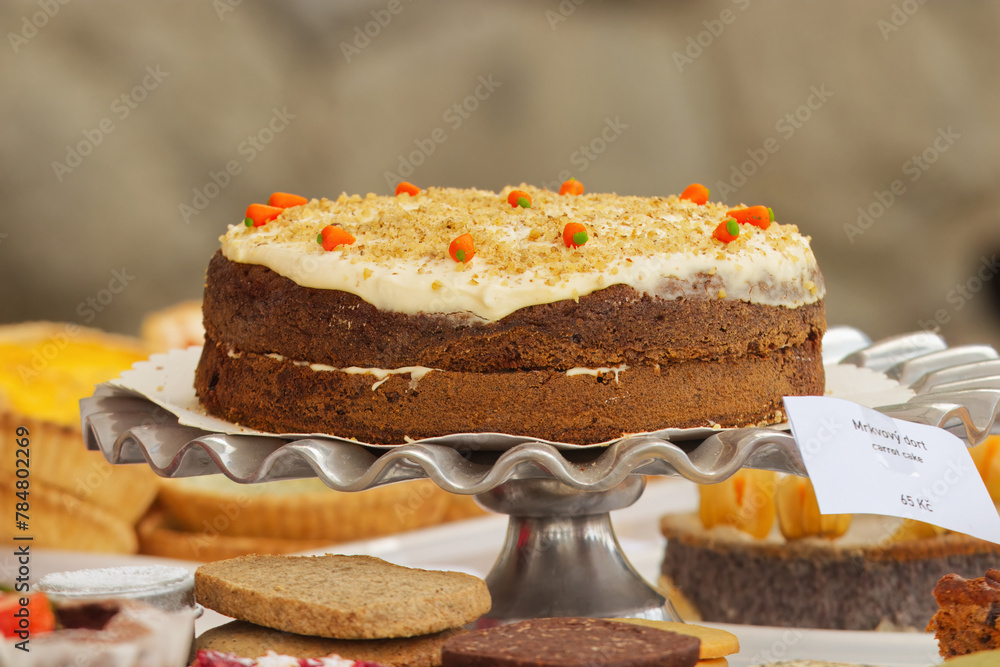 Carrot cake displayed on the table of the pastry stand at Prague Naplavka, farmers street food market in Czech Republic. Carrot cake displayed on the table of the pastry stand at Prague Naplavka, farmers street food market in Czech Republic.
