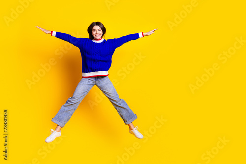 Canvas Print Full length photo of pretty teen girl jumping spread hands legs wear trendy knit