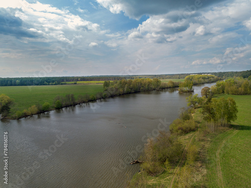 Drone view on River Moskva  Staritsa -old course    forest  with fence. In distance 2 white buildings of military sanatorium of Arkhangelskoe estate