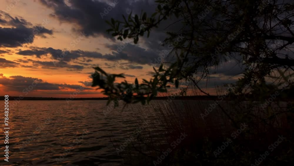 Romantic sunset on the lake, sunlight and clouds. Slow motion Romantic sunset on the lake, sunlight and clouds. Slow motion