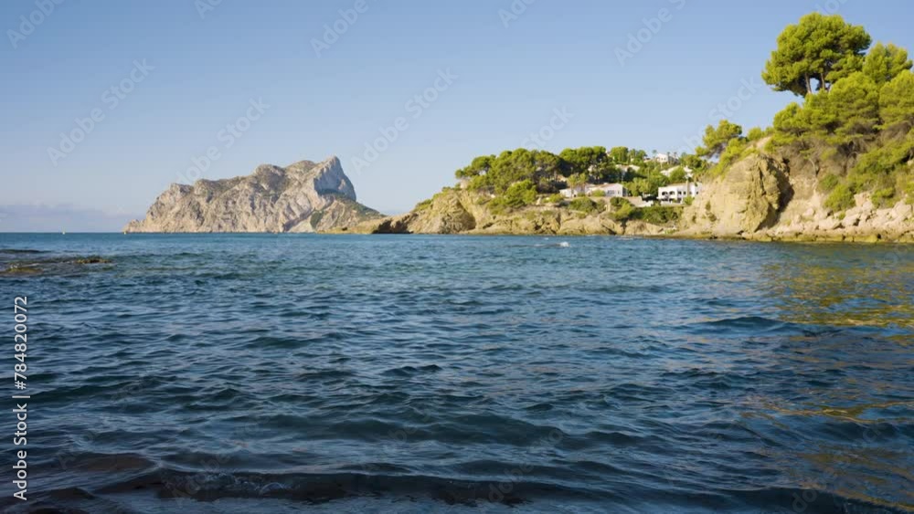 Gentle waves lap the shores of a quiet bay on the Spanish coastline during the summer tourist season.
Gentle waves lap the shores of a quiet bay on the Spanish coastline during the summer tourist season.