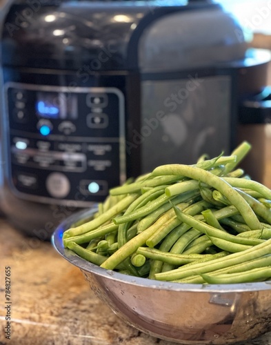 fresh green beans with blur pressure cooker background 