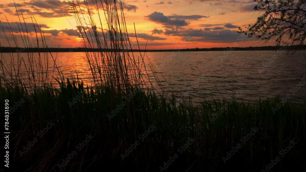 Romantic sunset on the lake, sunlight and clouds. Slow motion Romantic sunset on the lake, sunlight and clouds. Slow motion