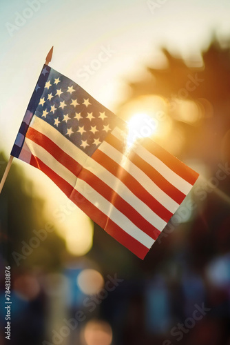 Close up of USA flag under sunbeam in outdoors. Vertical image. Celebrating Independence Day of America, 4th of July © LorenaPh