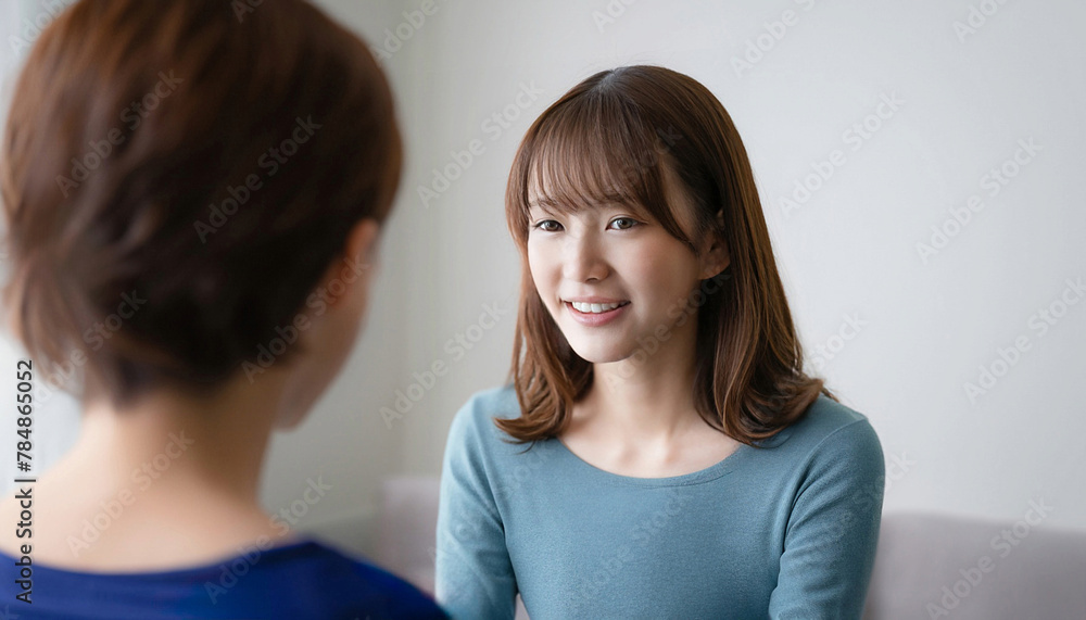 Young girl with oriental features talking to a child, child care concept Young girl with oriental features talking to a child, child care concept