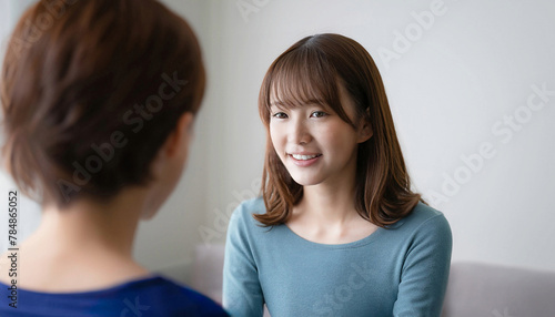 Young girl with oriental features talking to a child, child care concept